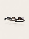 Three hair claw clips in black, clear, and tortoiseshell patterns, arranged horizontally on a light beige background.
